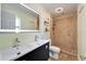 Bathroom showcasing double sink vanity, illuminated mirror and walk-in shower with designer tile at 8702 Driftwood Dr, Tampa, FL 33615
