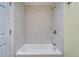 Bathroom features a tiled shower-over-tub with modern fixtures and bright, neutral finishes at 8702 Driftwood Dr, Tampa, FL 33615