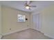 Bedroom featuring ceiling fan, closet and window allowing for ample light at 8702 Driftwood Dr, Tampa, FL 33615