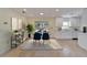 Open dining area adjacent to a kitchen featuring a modern table, chairs, and ample natural light at 8702 Driftwood Dr, Tampa, FL 33615