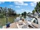 Peaceful waterfront dock featuring Adirondack chairs, perfect for enjoying serene water views and quiet moments at 8702 Driftwood Dr, Tampa, FL 33615