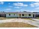 Charming single-story home featuring a well-maintained lawn, a spacious driveway and a covered front porch at 8702 Driftwood Dr, Tampa, FL 33615