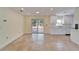 Open concept living area with sliding glass doors leading to a patio and a modern kitchen at 8702 Driftwood Dr, Tampa, FL 33615