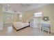 Spacious main bedroom with a ceiling fan, terrazzo floors, and large windows at 8702 Driftwood Dr, Tampa, FL 33615