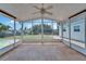 Enclosed lanai with lake views, tile floor, and neutral colors for a calm and relaxing outdoor space at 8702 Driftwood Dr, Tampa, FL 33615
