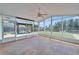 Bright sunroom featuring neutral flooring, views of the gazebo, and lush backyard at 8702 Driftwood Dr, Tampa, FL 33615