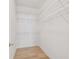 Organized walk-in closet with white wire shelving and wood flooring at 9101 Crystal Commons Way, Tampa, FL 33626