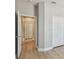 Hallway view with doors and closet, showcasing neutral walls and light wood-look flooring at 9101 Crystal Commons Way, Tampa, FL 33626
