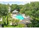 Relaxing community pool area with lounge chairs, lush greenery, and a pool house at 9101 Crystal Commons Way, Tampa, FL 33626