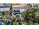 Aerial view of a property featuring a kidney-shaped pool surrounded by mature trees at 920 Palm Dr, Belleair Beach, FL 33786