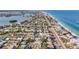 Expansive aerial view of a coastal community, showcasing beach proximity and diverse neighborhood layouts at 920 Palm Dr, Belleair Beach, FL 33786