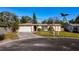 Cozy single-story home featuring a convenient attached garage and a well-maintained front lawn at 920 Palm Dr, Belleair Beach, FL 33786