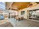 Covered back patio with a table, chairs, and ceiling fans, leading to a backyard oasis at 9229 Dayflower Dr, Tampa, FL 33647