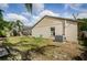 Backyard view showcasing the side of the house and a peek into the back patio at 9229 Dayflower Dr, Tampa, FL 33647