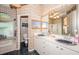 Bathroom featuring double sinks, framed mirrors and a separate tub and toilet area at 9229 Dayflower Dr, Tampa, FL 33647
