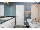 Bathroom featuring a blue wall, neutral flooring, toilet, shower, and a vanity with a white sink at 9229 Dayflower Dr, Tampa, FL 33647