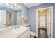 Bathroom featuring a blue wall, neutral flooring, toilet, shower, and a vanity with a white sink at 9229 Dayflower Dr, Tampa, FL 33647