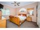 Bedroom with neutral carpet, a ceiling fan and natural light from the windows at 9229 Dayflower Dr, Tampa, FL 33647