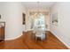 Elegant dining room with a glass table, decorative chairs and hardwood floors at 9229 Dayflower Dr, Tampa, FL 33647