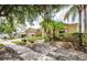 A view of the home's exterior featuring landscaping and partial driveway at 9229 Dayflower Dr, Tampa, FL 33647