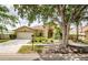 Charming home with a manicured front yard and a two-car garage at 9229 Dayflower Dr, Tampa, FL 33647