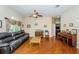 Cozy living room featuring hardwood floors, a ceiling fan, and a comfortable couch at 9229 Dayflower Dr, Tampa, FL 33647
