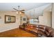 Spacious living room featuring a large sectional sofa, hardwood floors and access to other rooms at 9229 Dayflower Dr, Tampa, FL 33647