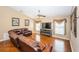 The living room offers a large sectional sofa, hardwood floors and large windows for natural light at 9229 Dayflower Dr, Tampa, FL 33647