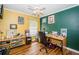 Office featuring yellow and green walls, hard wood floors and a large desk with a rolling chair at 9229 Dayflower Dr, Tampa, FL 33647