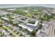 Aerial view of community showcasing its buildings, landscaping, nearby lake, and surrounding neighborhood at 9945 47Th N Ave # 208, St Petersburg, FL 33708