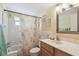 Bathroom featuring a shower with seashell shower curtain, tile surround, and a sink with vanity at 9945 47Th N Ave # 208, St Petersburg, FL 33708