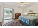 Comfortable bedroom featuring a ceiling fan, area rug, and natural light at 9945 47Th N Ave # 208, St Petersburg, FL 33708