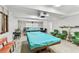 The billiards room features two pool tables with covers, and cozy seating, ideal for recreation and relaxation at 9945 47Th N Ave # 208, St Petersburg, FL 33708