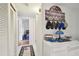 A hallway decorated with a coastal themed sign, and a view into other rooms at 9945 47Th N Ave # 208, St Petersburg, FL 33708