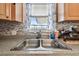 Double sink in the kitchen beneath a large window at 9945 47Th N Ave # 208, St Petersburg, FL 33708