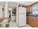 Bright kitchen features a full-size refrigerator and tile flooring at 9945 47Th N Ave # 208, St Petersburg, FL 33708