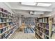 A cozy library with floor-to-ceiling bookshelves and a comfortable rocking chair, creates an inviting space for reading at 9945 47Th N Ave # 208, St Petersburg, FL 33708