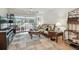 Cozy living room featuring a tropical-themed sofa and an ocean-inspired area rug near a sliding glass door at 9945 47Th N Ave # 208, St Petersburg, FL 33708