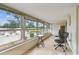 Enclosed lanai with tile flooring, large windows, and comfortable seating ideal for enjoying the outdoors at 9945 47Th N Ave # 208, St Petersburg, FL 33708