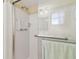Shower with safety bars, clear glass, and bright lights for a clean and accessible experience at 9945 47Th N Ave # 208, St Petersburg, FL 33708