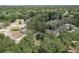 Aerial view of home, showcasing lush landscaping and proximity to a serene lake at 10119 Cliff Cir, Tampa, FL 33612