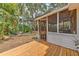 Charming screened porch and backyard with mature trees extending to the water at 10119 Cliff Cir, Tampa, FL 33612