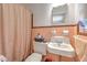 Cozy bathroom featuring a vintage sink and charming salmon-colored tiling at 10119 Cliff Cir, Tampa, FL 33612
