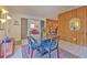 Open dining room with wood paneling, stylish rug, access to the living room, and tile flooring at 10119 Cliff Cir, Tampa, FL 33612