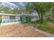 Charming one-story home with unique architecture, stylish awning, and gravel landscaping at 10119 Cliff Cir, Tampa, FL 33612
