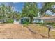Charming single-story home with beautiful mature trees and low maintenance gravel landscaping at 10119 Cliff Cir, Tampa, FL 33612