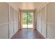 Hallway with dual closets leading to a sliding glass door with a view to the backyard and patio at 10119 Cliff Cir, Tampa, FL 33612