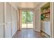 Hallway with dual closets, laundry, and sliding glass doors overlooking a backyard with a deck at 10119 Cliff Cir, Tampa, FL 33612