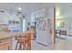 Efficient kitchen with white appliances, tiled floor, and a breakfast bar perfect for quick meals and socializing at 10119 Cliff Cir, Tampa, FL 33612