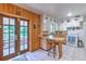 Cozy kitchen with wooden accents, classic white cabinetry, and charming breakfast bar seating near the doors at 10119 Cliff Cir, Tampa, FL 33612